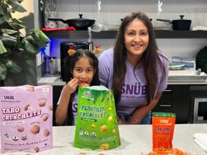 The Snüb founder and her daughter in the kitchen with Taro Crunchlets, Plantain Crunchlets and Caroonch packs